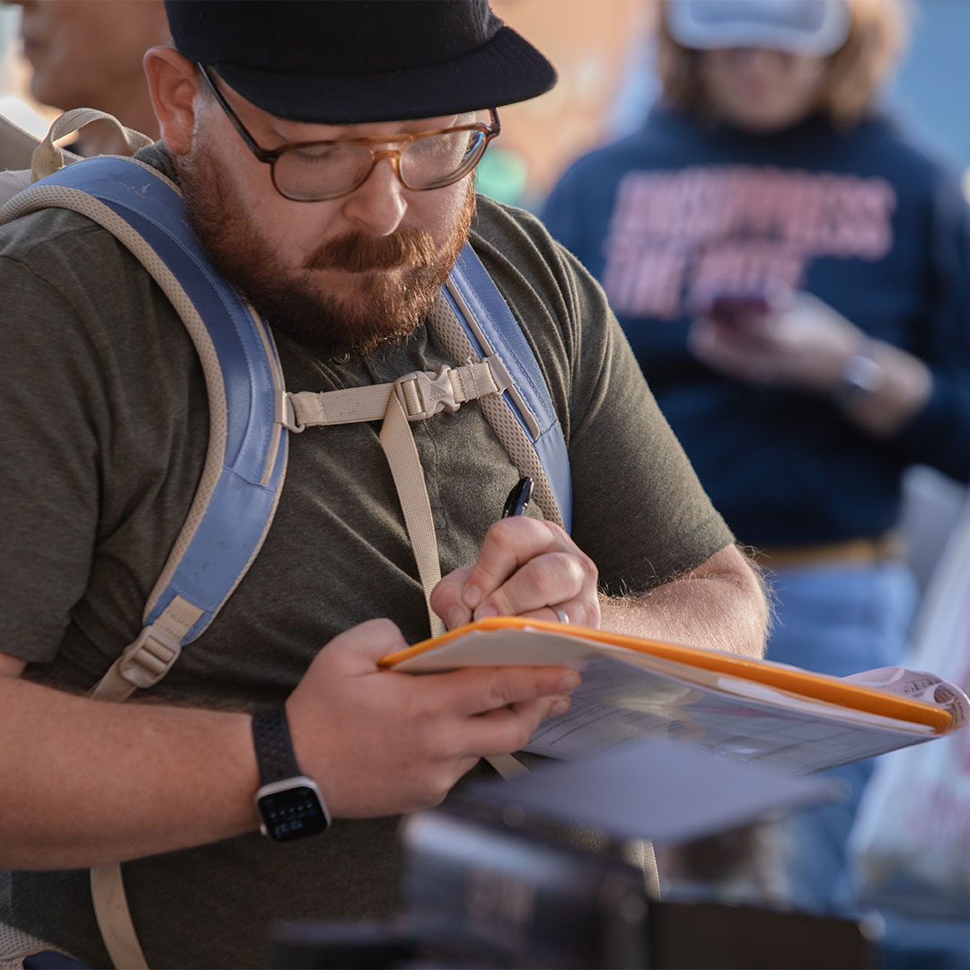 Your 2 Cents Portland supporter filling out a petition