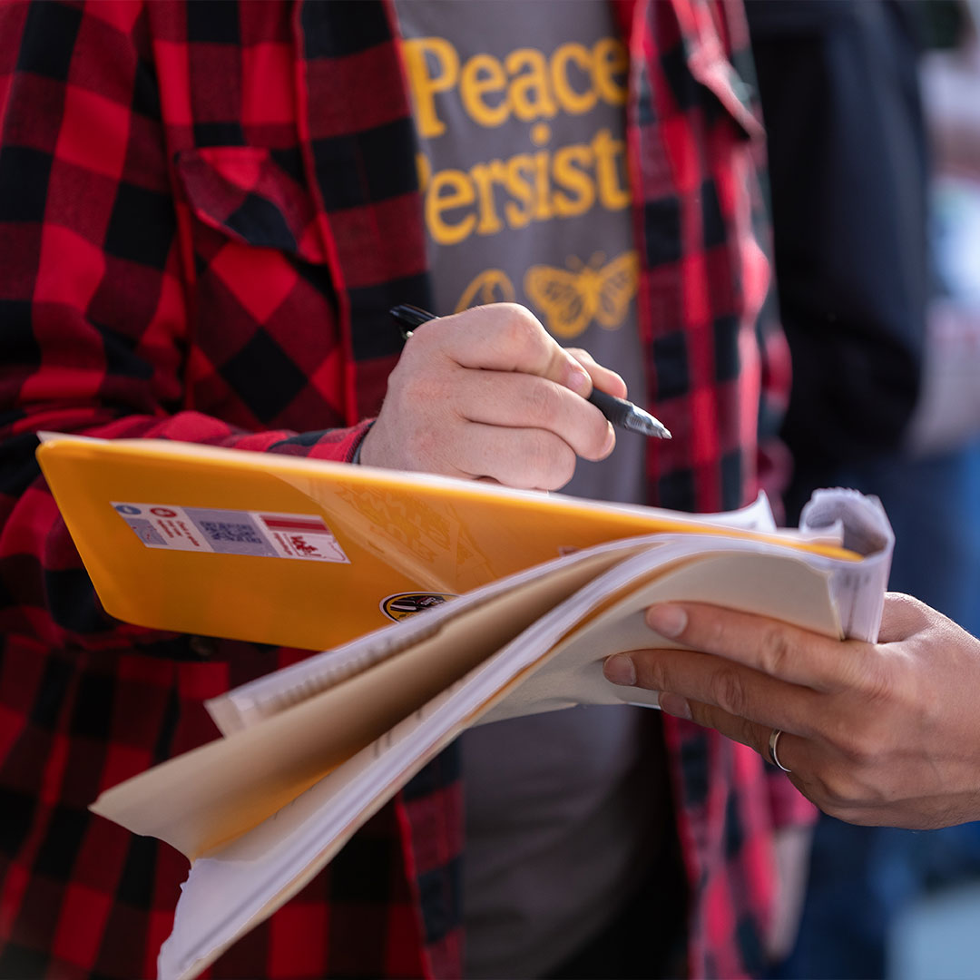 Your 2 Cents Portland supporter filling out a petition
