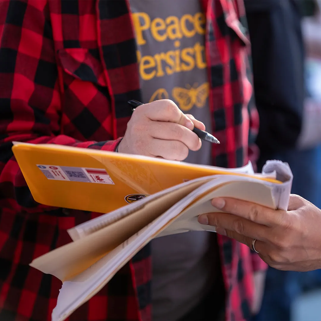 Your 2 Cents Portland supporter filling out a petition